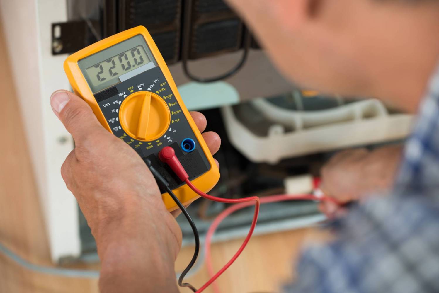 Image of Professional Electrician Using a Multimeter