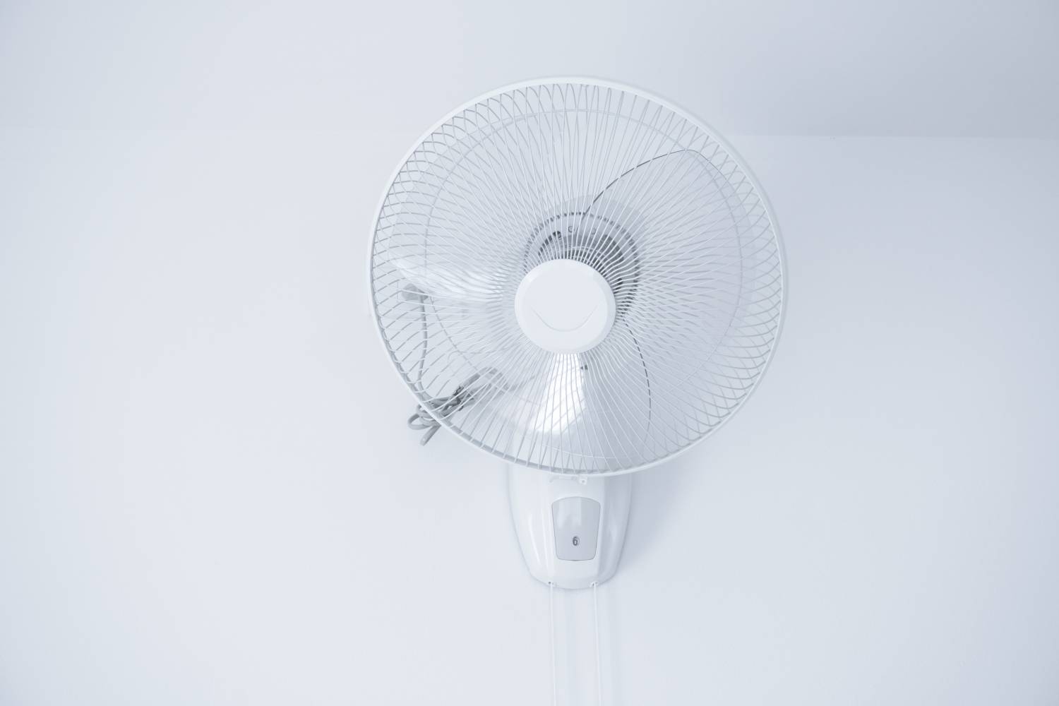 Image of wall mounted fan in room